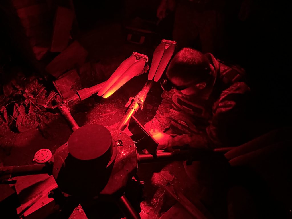 Photo: Soldiers from Yasni Ochi loading an anti-tank mine onto the drone. Credit: Photo Courtesy of David Kirichenko.