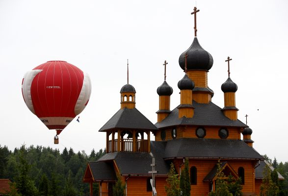 Photo: A hot air balloon rises near Orthodox church at the Museum complex of ancient crafts and technologies Dudutki, Belarus, a country near Lithuania. Picture taken June 16, 2018. Credit: REUTERS/Vasily Fedosenko