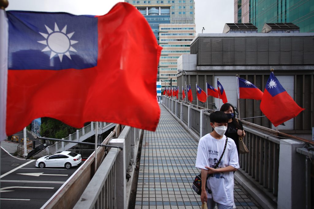 Photo: Two youngsters walk across a footbridge in Taipei, where Taiwan flags flutter ahead of the island’s national day, amid rising tensions with China, in Taipei, Taiwan, on 5 October 2022. The self governing island is facing low-birth rates affect school admission rate and military recruiting, with tensions increasing in the Taiwan Strait, as Beijing steps up military exercises. Taiwan has also been fostering relationships with European countries like Germany, Lithuania, Estonia and France, as well as The US, UK and Canada. Credit: Ceng Shou Yi/NurPhoto.