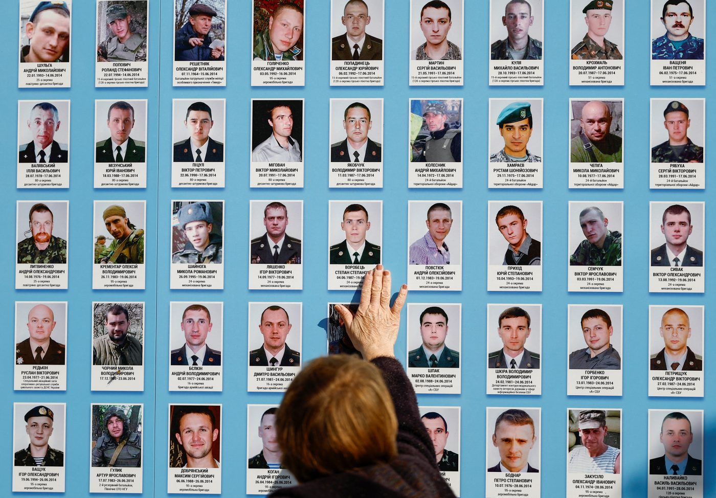 Photo: A woman touches a portrait of her relative as she visits the Memory Wall of Fallen Defenders during the Defenders of Ukraine Day, amid Russia's attack on Ukraine, in Kyiv, Ukraine October 1, 2024. Credit: REUTERS/Valentyn Ogirenko