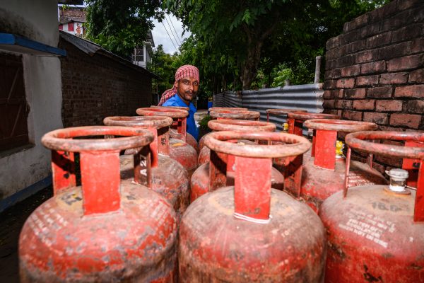 Photo: Oil marketing companies in India have cut the price of 19kg commercial LPG by Rs 99.75 ($1.33) while keeping domestic cooking gas pricing unaffected. Domestic cooking gas prices fluctuate on a monthly basis and are partly influenced by the global crude oil rate. The revised prices on the 19kg commercial LPG cylinder came into force on 1 August and cost INR1,680 ($22.40) for retail sales in Delhi, Rs1,802.50 in Kolkata, and Rs 1,640.50 in Mumbai. A distributor of Bharatgas LPG Services is distributing gas door-to-door in trolleys through his employees at Tehatta, West Bengal; India on 02/08/2023. Credit: Soomyabrata Roy/NurPhotp