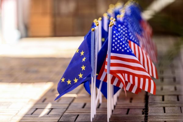 Photo: US flags with EU flags on a terrace. Credit: imago images/Future Image via Reuters Connect