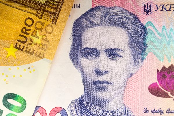 Photo: In this photo illustration, 50 euro note and 200 Ukrainian Hryvnias banknote with the image of Lesya Ukrainka are seen displayed. Credit: Karol Serewis / SOPA Images/Sipa USA