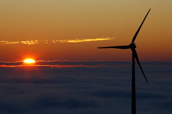 Photo: A wind turbine stands out against the sky as the sun sets over the Black Forest Brandenkopf lookout near Oberharmersbach, Germany, November 13, 2022. Credit: REUTERS/Joachim Herrmann