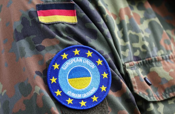 Photo: Details of a patch are seen on a German soldier's uniform at a training site where Ukrainian soldiers undergo maintenance training on Leopard 1A5 tanks, at the German army Bundeswehr base, part of the EU Military Assistance Mission in support of Ukraine (EUMAM Ukraine), on the day of German Defence Minister Boris Pistorius and Danish acting Defence Minister Troels Lund Poulsen's visit, in Klietz, Germany, May 5, 2023. Credit: REUTERS/Fabrizio Bensch