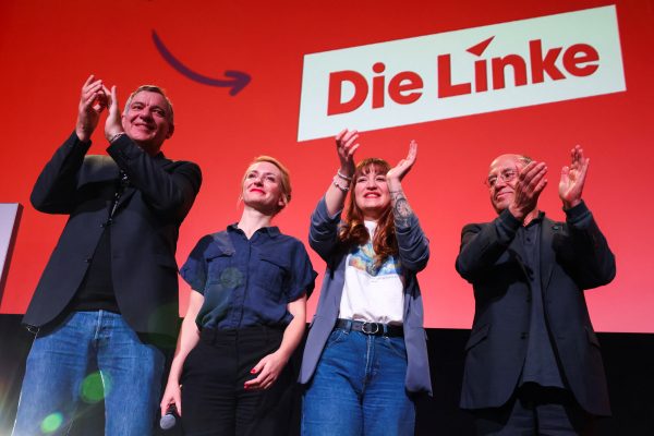 Photo: Ines Schwerdtner, Gregor Gysi, Jan van Aken and Heidi Reichinnek of Germany's left party Die Linke gesture on stage on the day of a campaign event, in Berlin, Germany, February 21, 2025. Credit: REUTERS/Christian Mang