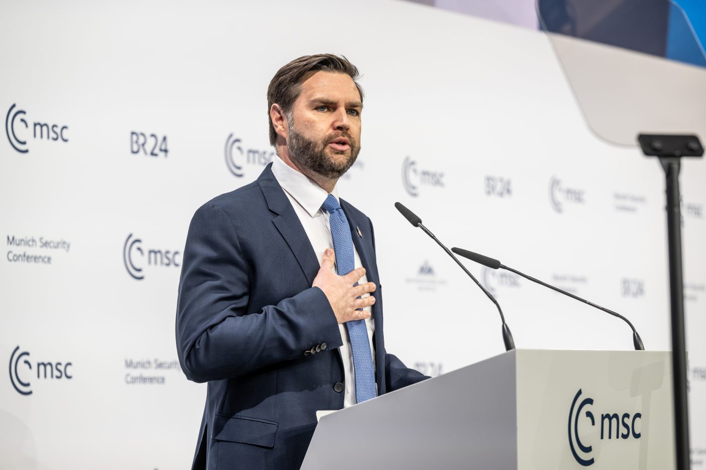 Photo: Vice President J. D. Vance, speaks at the 61st Munich Security Conference. He stands at a podium, emphasizing key points on international security. Credit: David Hecker/MSC