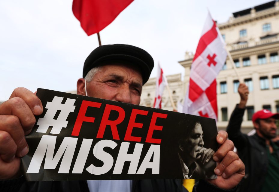 Photo: A participant holds a banner during a rally demanding the release of jailed Georgian former President Mikheil Saakashvili in Tbilisi, Georgia October 14, 2021. Credit: REUTERS/Irakli Gedenidze