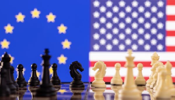 Photo: Chess pieces are seen in front of displayed U.S. and EU flags in this illustration taken January 25, 2022. Credit: REUTERS/Dado Ruvic/Illustration