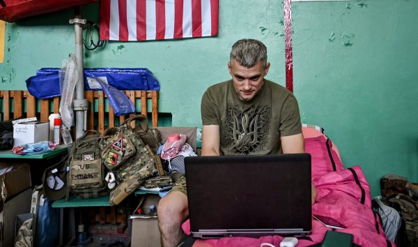 Photo: A medic works on a laptop at a stabilization point of the medical service of one of the brigades fighting against Russian invaders in the Zaporizhzhia direction, Zaporizhzhia Region, southeastern Ukraine. Credit: Dmytro Smolienko/Ukrinform/Sipa USA