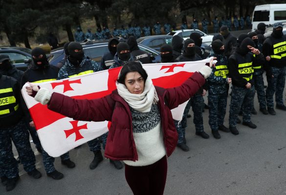 Photo: A protester holds a Georgian flag during an anti-government rally demanding new parliamentary elections in Tbilisi, Georgia February 2, 2025. Credit: REUTERS/Irakli Gedenidze