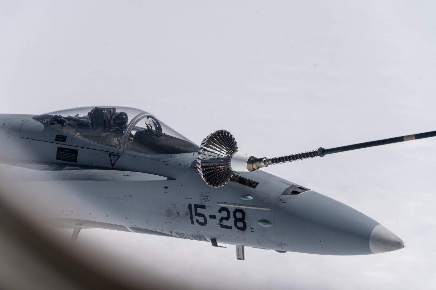 Photo: A Spanish F-18 refuels in mid air. Spanish fighter jets hit the throttles and took to the skies over the Baltic Sea region during Exercise Ramstein Alloy 2024. An annual air policing exercise, Ramstein Alloy tests the ability of NATO’s air forces to safeguard the airspace over and around NATO Allies. For this year’s exercise, hosted by Estonia, Spanish Air Force EF-18 Hornet strike fighters took off from Šiauliai Air Base in Lithuania, where they are currently stationed on a Baltic Air Policing rotation. Overhead a Spanish Air Force A400M refueler gassed up Spanish and Finnish fighters. Air policing is a peacetime activity conducted by NATO Allies 24 hours a day, 365 days a year, to ensure the integrity of Allied airspace. As part of air policing, fighters regularly scramble to investigate suspicious air contacts that fail to broadcast an identification code, or fail to respond to air traffic controller hails. Sometimes, these aircraft are commercial planes experiencing a communications malfunction; others are Russian military aircraft flying near NATO Allies in international airspace. Credit: NATO flickr via https://flic.kr/p/2pNEe9c