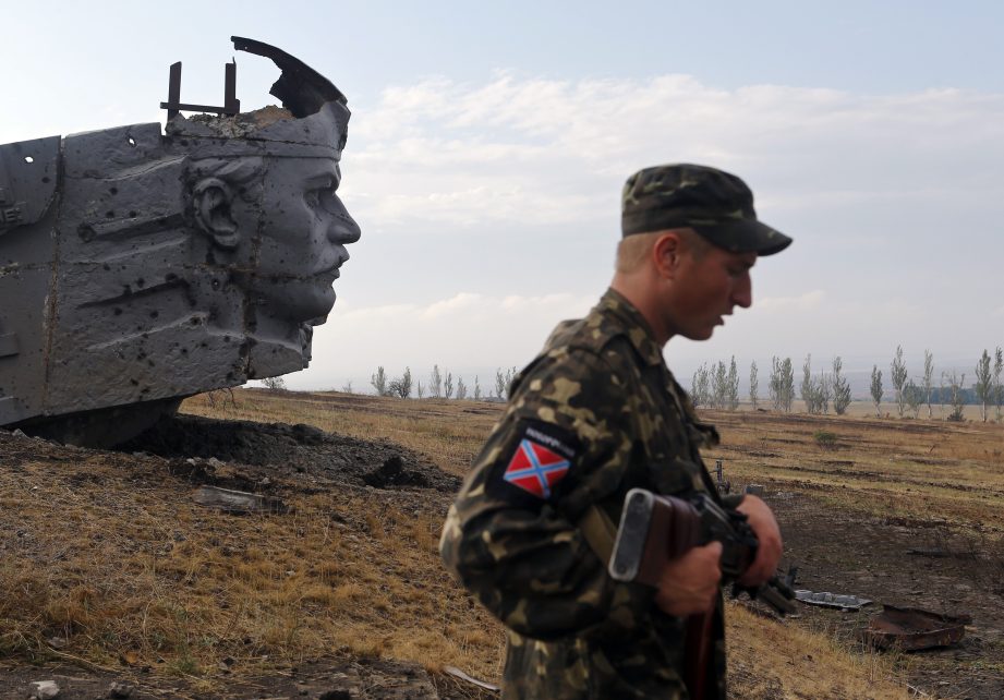 Photo: A Pro-Russian separatist stands near the damaged war memorial at Savur-Mohyla, a hill east of the city of Donetsk, August 28, 2014. Ukrainian President Petro Poroshenko said on Thursday that Russian forces had entered his country and the military conflict was worsening after Russian-backed separatists swept into a key town in the east. Credit: REUTERS/Maxim Shemetov
