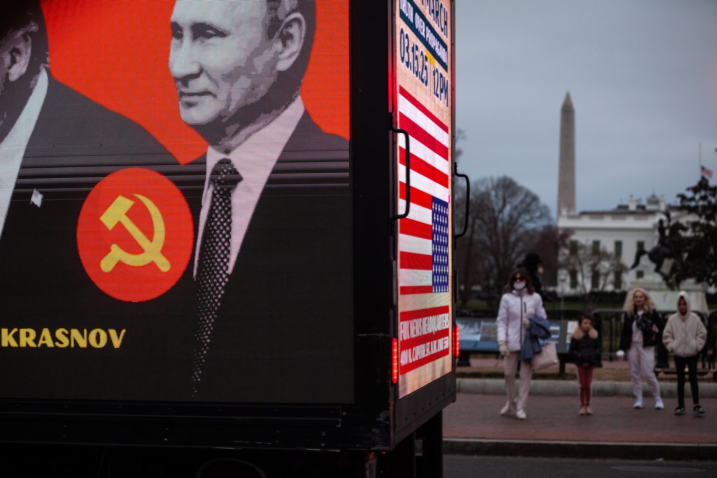 Photo: People watch as a billboard truck criticizing Donald Trump's cosy relationship with Russian President Vladimir Putin, part of a demonstration by hundreds of veterans outside the White House following a demonstration on the National Mall against Donald Trump, Elon Musk, and the Department of Government Efficiency (DOGE) in Washington on March 14, 2025. Through DOGE, Musk and Trump have fired thousands of federal government employees and shuttered entire agencies, including those mandated by Congress like USAID. Credit: Allison Bailey/NurPhoto via Reuters Connect
