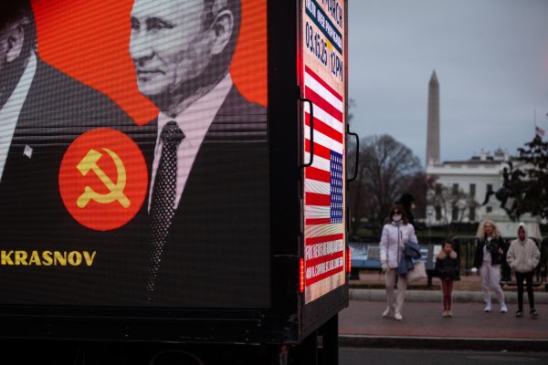 Photo: People watch as a billboard truck criticizing Donald Trump's cosy relationship with Russian President Vladimir Putin, part of a demonstration by hundreds of veterans outside the White House following a demonstration on the National Mall against Donald Trump, Elon Musk, and the Department of Government Efficiency (DOGE) in Washington on March 14, 2025. Through DOGE, Musk and Trump have fired thousands of federal government employees and shuttered entire agencies, including those mandated by Congress like USAID. Credit: Allison Bailey/NurPhoto via Reuters Connect