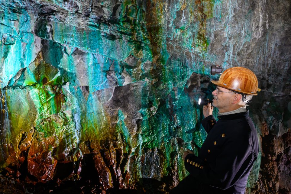 Photo: Thomas Wäsche, head of the "ErlebnisZentrum Bergbau Röhrigschacht Wettelrode", stands almost 300 meters underground in the so-called Green Vault. The sintering is caused by dissolved minerals from the limestone. The color palette ranges from strong shades of brown to white, green, turquoise, blue and black. The first miners began digging for copper ore in the Mansfeld region 825 years ago. Intensive mining was carried out from 1750 onwards. A total of around 2.6 million tons of copper and 14,213 tons of silver were extracted from the ore in the area. Until December, a total of 38 events will commemorate the beginning of mining and smelting in the Mansfeld region. As a major copper and silver producer, the region contributed to economic development for centuries. Credit: Hendrik Schmidt/dpa via Reuters Connect.
