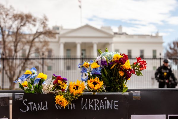 Photo: Flowers line the top of the memorial above a sign urging the US to "stand with Ukraine," during a vigil at the White House for those killed in the Russian war. Hundreds of people gathered to remember the victims of the ongoing Russian war and honor their lives. The event was sponsored by United Help Ukraine and Ukrainian American Activists, both U.S.-based assistance and advocacy organizations. Credit: Allison Bailey/NurPhoto via Reuters