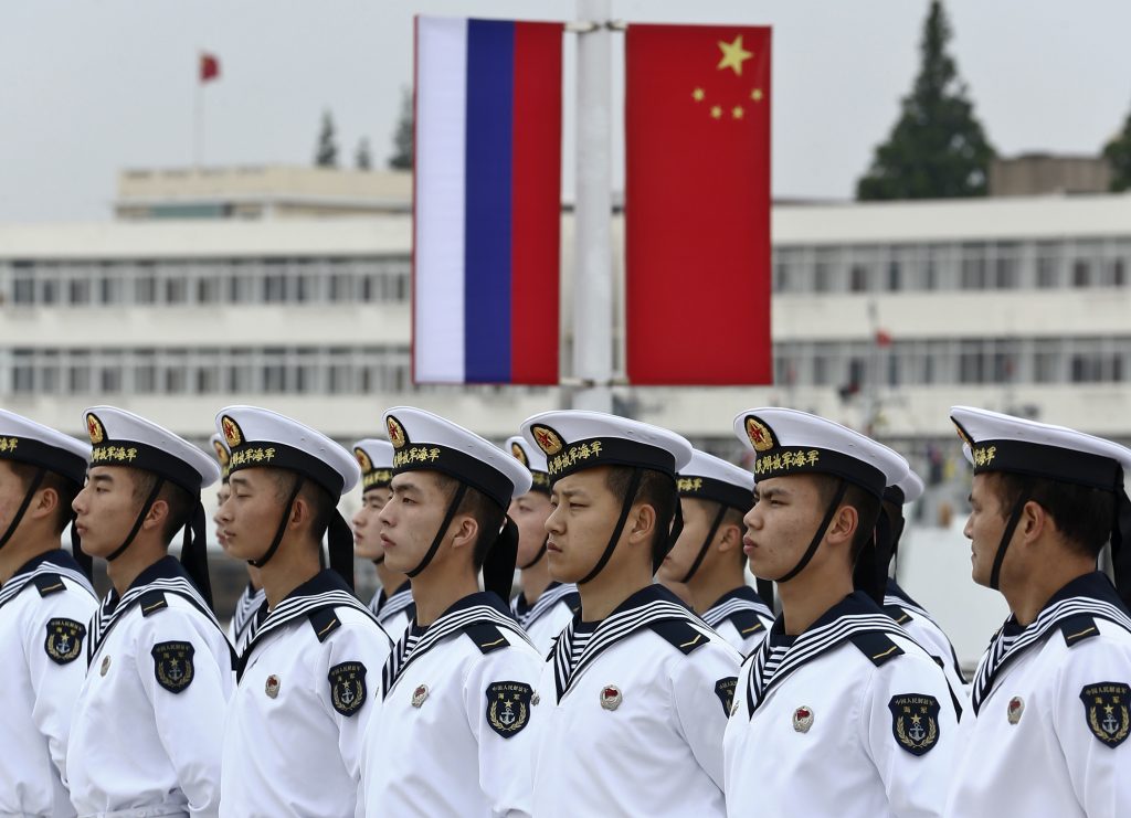 Photo: Chinese sailors stand in formation in front of national flags of Russia (L) and China, as they get ready for a welcoming ceremony for Russian naval vessels ahead of the "Joint Sea-2014" naval drill, at a port in Shanghai, May 18, 2014. Six ships from the Russian Pacific Fleet will take part in the drill in the northern part of the East China Sea between May 20 and 26. A total of 14 surface ships, two submarines, nine fixed-wing warplanes, six shipboard helicopters and two operational detachment-alphas (ODAs) have rallied in Shanghai on Sunday, Xinhua News Agency reported. Picture taken May 18, 2014. Credit: REUTERS/China Daily