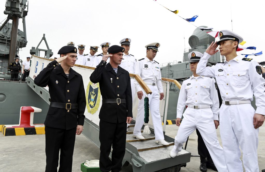 Photo: Russian sailors (L) salute to Chinese sailors as they visit Russian guided missile cruiser Varyag ahead of the "Joint Sea-2014" naval drill, at a port in Shanghai, May 19, 2014. Six ships from the Russian Pacific Fleet will take part in the drill in the northern part of the East China Sea between May 20 and 26. A total of 14 surface ships, two submarines, nine fixed-wing warplanes, six shipboard helicopters and two operational detachment-alphas (ODAs) have rallied in Shanghai on Sunday, Xinhua News Agency reported. Credit: REUTERS/China Daily