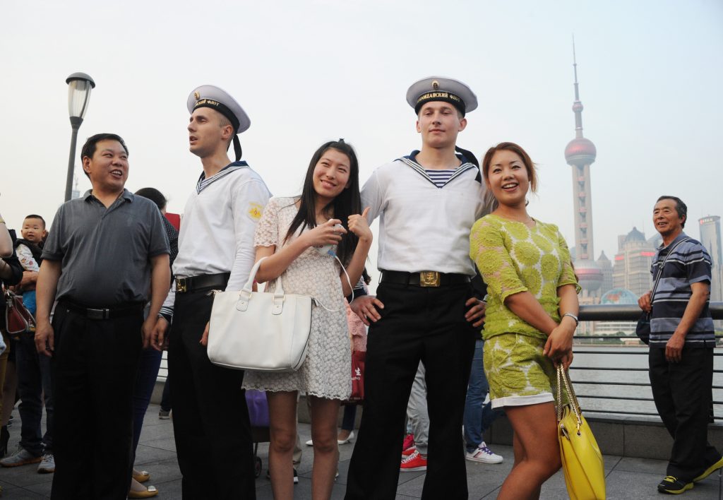 Russian sailors pose for photos with Chinese tourists on the promenade of the Bund against the skyline of Pudongs Lujiazui Financial District, in Shanghai, China, 20 May 2014. Credit: Oriental Image via Reuters Connect Sailors from the navy visited Shanghai on Tuesday (20 May 2014) as a joint exercise was set to begin in the East China Sea. Crew members from the Russian missile cruiser Varyag were given a guided tour of the Zhengzhou, a missile destroyer from the Peoples Liberation Army navy. Their Chinese peers from the Zhengzhou visited the Varyag. Officers from both navies said they are looking forward to working together and achieving success in the drill. An officer from the Varyag, who identified himself as Vladislav, said he is impressed by the advanced weapons on the Chinese ship, adding this is the second time that he has been involved in a drill with the Chinese navy. A squadron of six ships from the Russian Pacific Fleet arrived at a military port in Shanghai on Sunday afternoon. A total of 14 ships, two submarines, nine fixed-wing aircraft and several helicopters from the two navies will take part in Joint Sea-2014 drill, which bagan on Tuesday and last seven days. The drill will test the two parties capabilities to launch joint operations such as anti-ship strikes, anti-submarine combat and rescue of hijacked vessels.No Use China. No Use France.