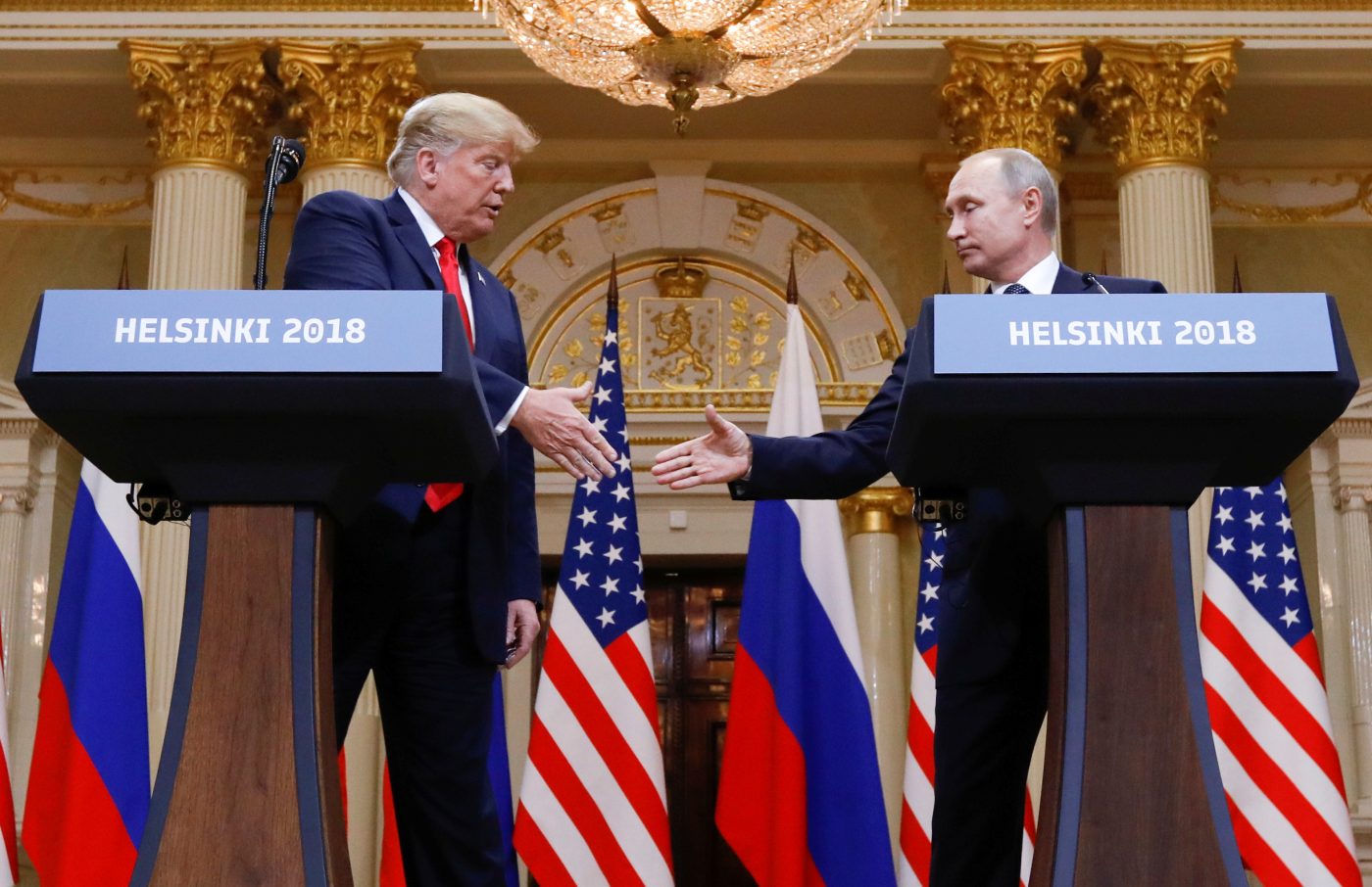 Photo: U.S. President Donald Trump and Russia's President Vladimir Putin shake hands during a joint news conference after their meeting in Helsinki, Finland, July 16, 2018. Credit: REUTERS/Kevin Lamarque