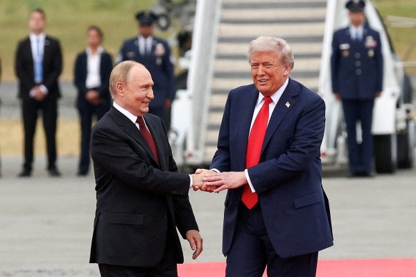 Photo: U.S. President Donald Trump shakes hand with Russian President Vladimir Putin, as they meet to negotiate for an end to the war in Ukraine, at Joint Base Elmendorf-Richardson in Anchorage, Alaska, U.S., August 15, 2025. Credit: REUTERS/Kevin Lamarque/File Photo