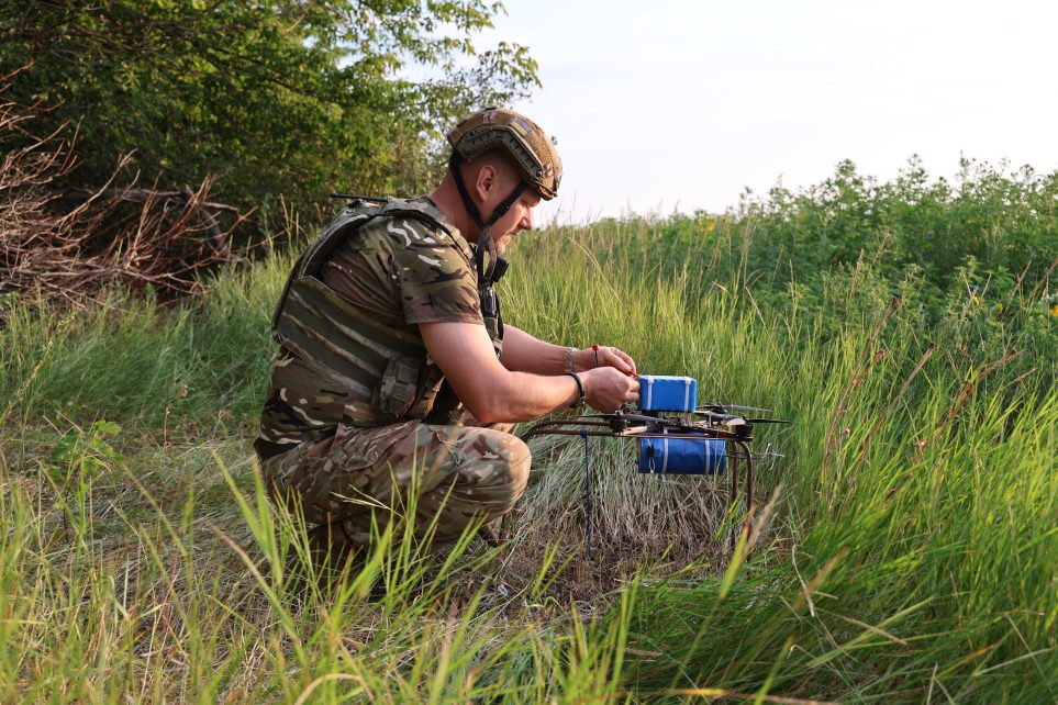Photo: A soldier from the Unmanned Systems Battalion of Ukraine’s 110th Separate Mechanized Brigade prepares the explosives on an FPV drone. Credit: Courtesy of David Kirichenko