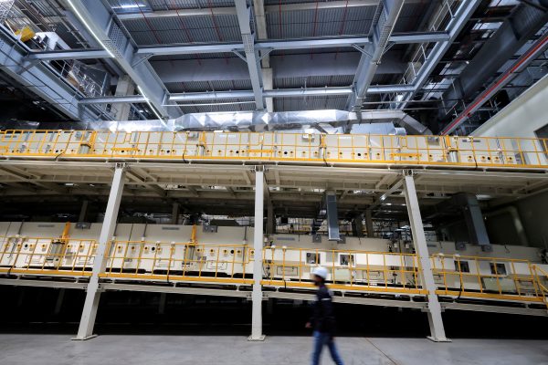 Photo: A person walks by the electric car battery production line inside the gigafactory of Automotive Cells Company (ACC), a joint venture of Stellantis, TotalEnergies and Mercedes, during its inauguration in Billy-Berclau-Douvrin, northern France, May 30, 2023. Credit: REUTERS/Pascal Rossignol