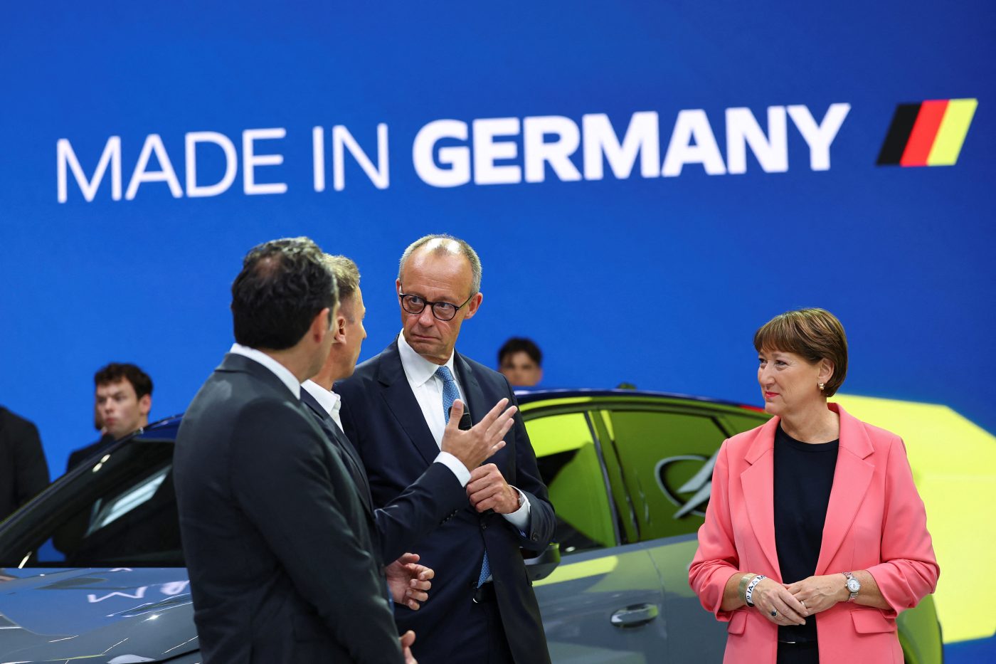 Photo: German Chancellor Friedrich Merz and German Association of the Automotive Industry (VDA) President Hildegard Mueller tour the Opel fair booth at the IAA Mobility 2025 auto show in Munich, Germany, September 9, 2025. Credit: REUTERS/Kai Pfaffenbach