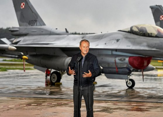 Photo: Polish Prime Minister Donald Tusk stands in front of Polish Air Force F-16 fighter jets as he holds a press conference regarding the threat posed by Russian drones in Polish airspace at the 32nd Tactical Air Base in Lask, about 30 km south-west of Lodz, Poland, September 11, 2025. Credit: Agencja Wyborcza.pl/Tomasz Stanczak via REUTERS