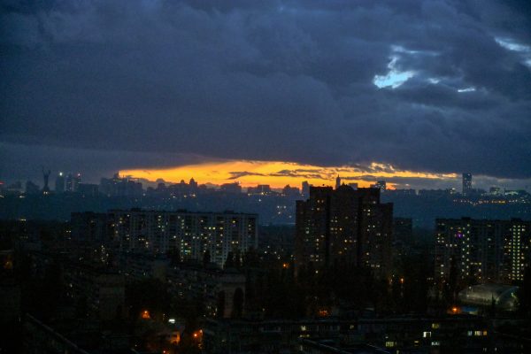 Photo: Partially blacked-out residential blocks stand under the orange evening sky as the city faces scheduled power outages caused by Russian strikes on Ukraine's energy infrastructure and higher electricity demand in cold weather in Kyiv, Ukraine, on October 29, 2025. Credit: Photo by Yevhen Kotenko/Ukrinform