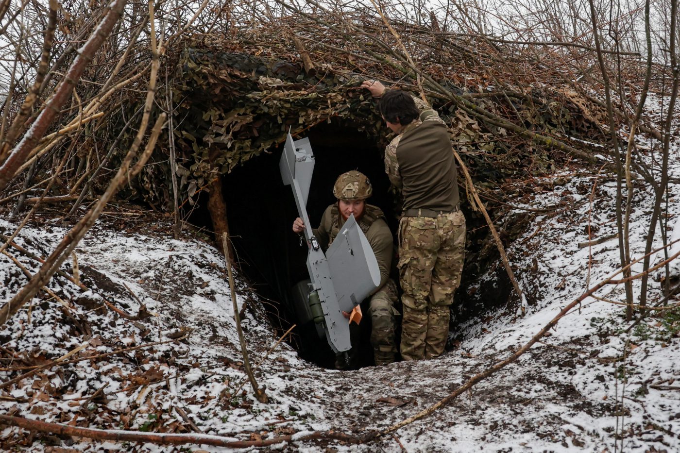 Photo: Servicemen of the 66th Separate Mechanized Brigade named after Prince Mstyslav the Brave leave their dugout with a Darts middle range strike unmanned aerial vehicle before launching it towards Russian troops from their position near a front line, amid Russia's attack on Ukraine, in Donetsk region, Ukraine, December 16, 2025. Credit: REUTERS/Sofiia Gatilova