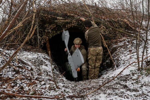 Photo: Servicemen of the 66th Separate Mechanized Brigade named after Prince Mstyslav the Brave leave their dugout with a Darts middle range strike unmanned aerial vehicle before launching it towards Russian troops from their position near a front line, amid Russia's attack on Ukraine, in Donetsk region, Ukraine, December 16, 2025. Credit: REUTERS/Sofiia Gatilova