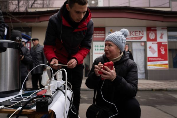 Photo: Residents are seen checking and charging their phones at a temporary charging point. Residents of Kherson are still overjoy about the liberation of the city, putting more than 8 months of occupation to an end. However, the southern regional capital still has no electricity, water and minimum of signal and food supply. Credit: Photo by Ashley Chan / SOPA Images/Sipa USA