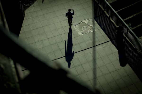 Photo: A man holding a mobile phone is seen walking in Warsaw, Poland on 13 May, 2204. Credit: Photo by Jaap Arriens/NurPhoto